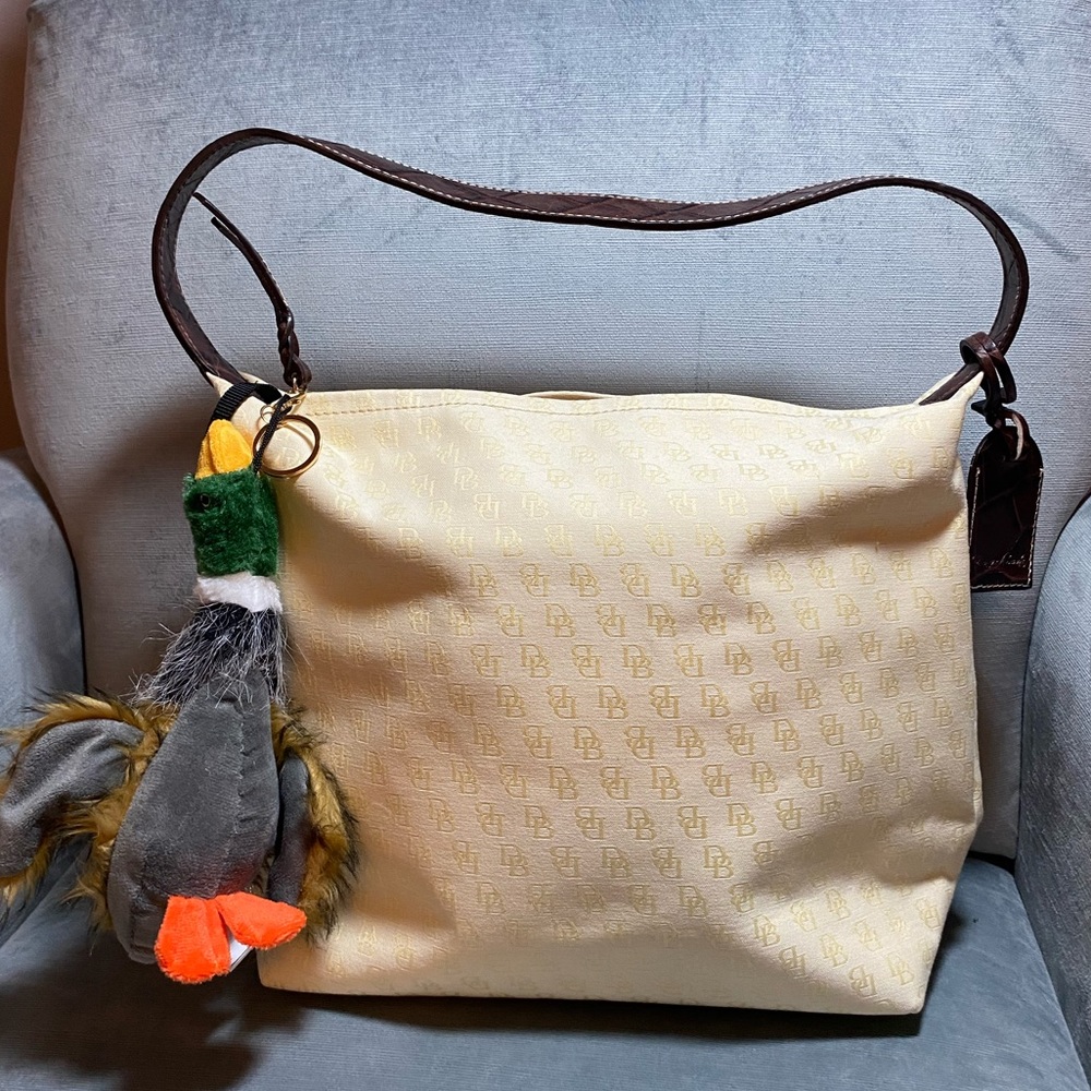 Pristine like new Dooney and Bourke cream, shoulder bag w/ plush duck & dust bag